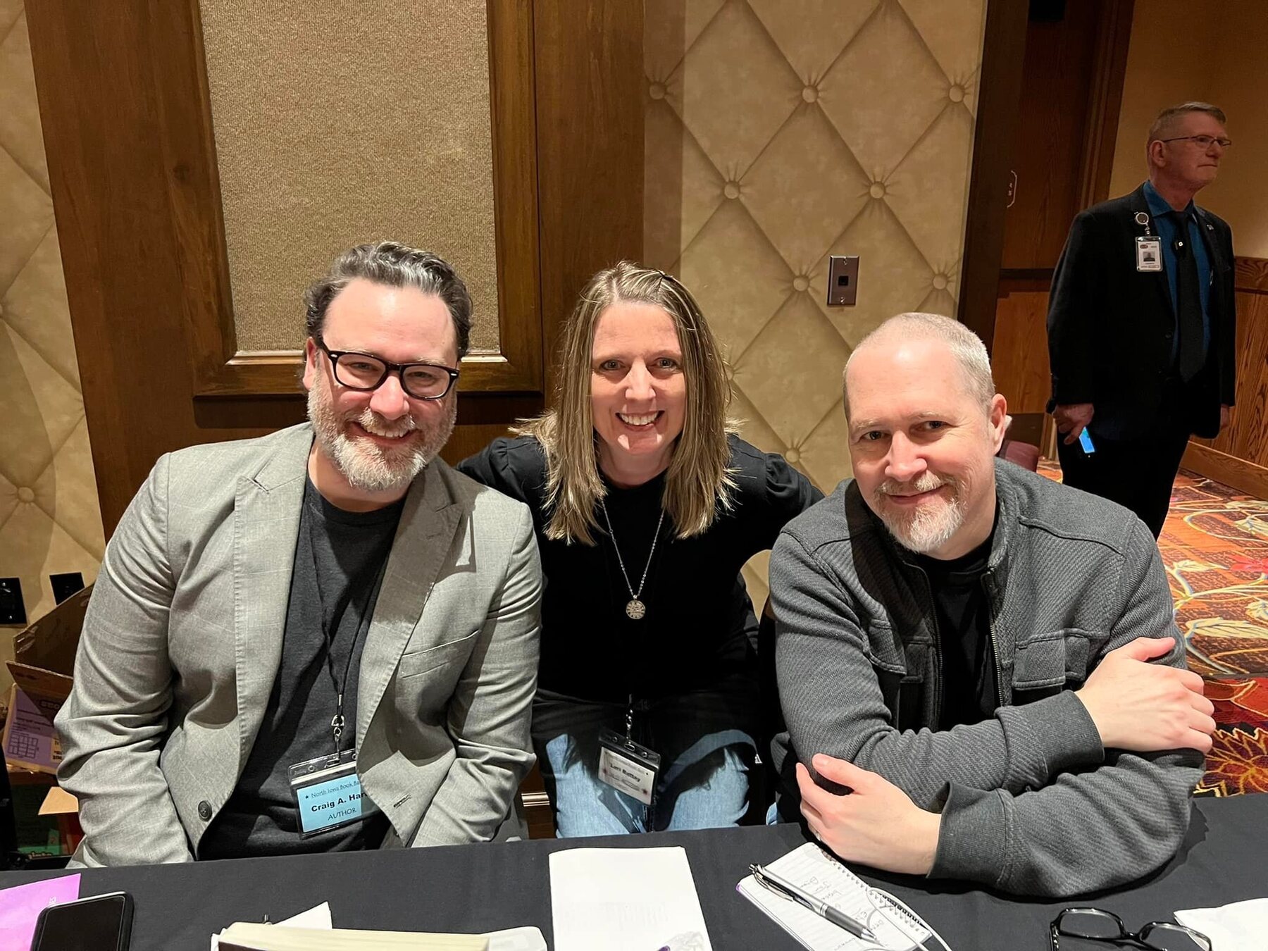 Craig A. Hart seated with fellow writers at an author conference