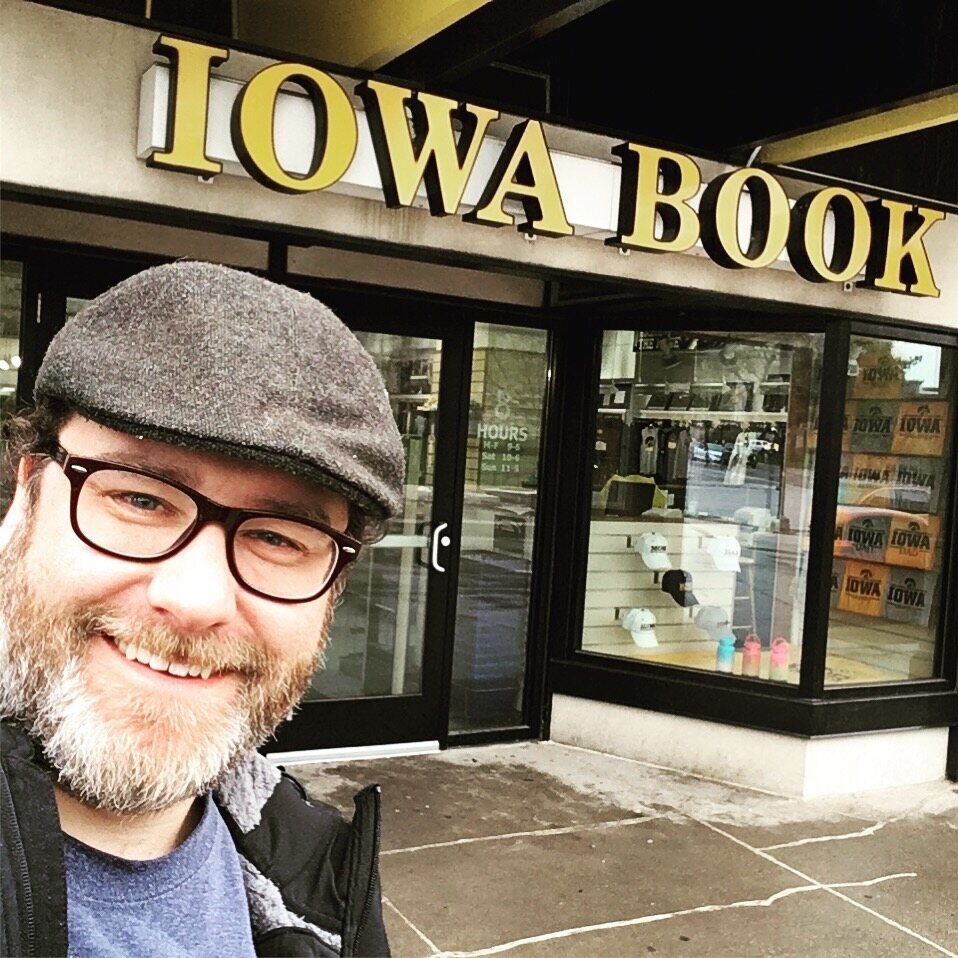 Craig A. Hart smiling outside Iowa Book in Iowa City