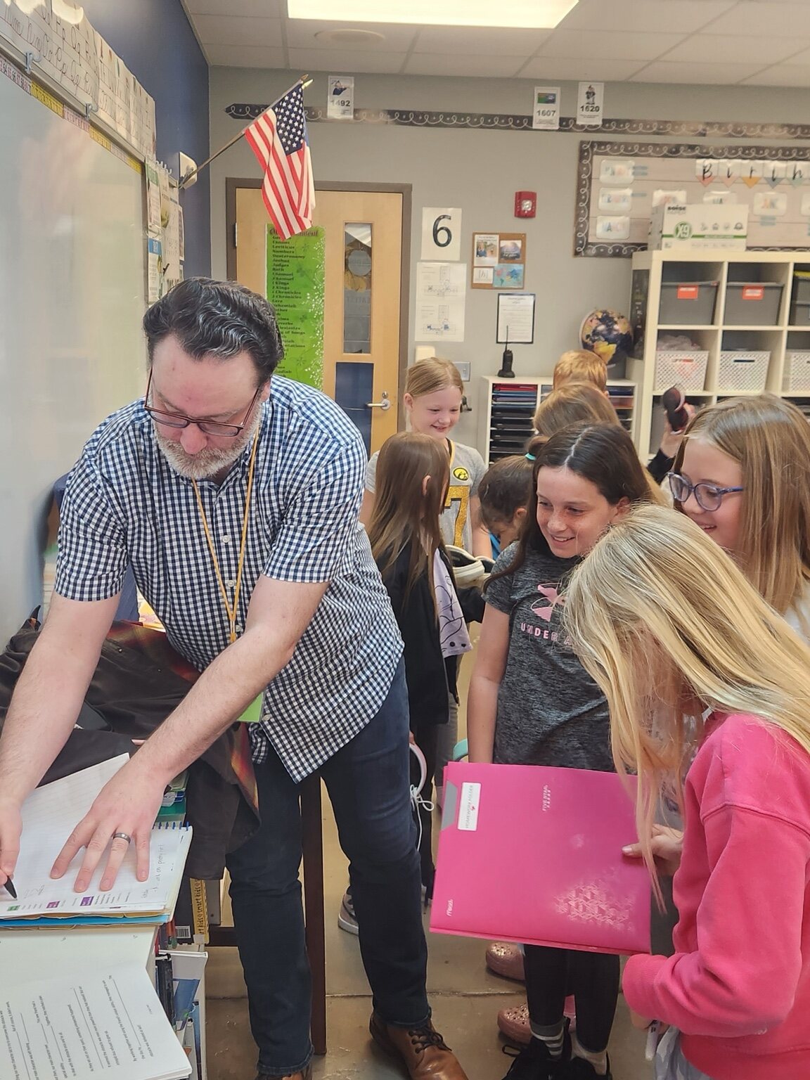 Craig A. Hart talking with students around a classroom table